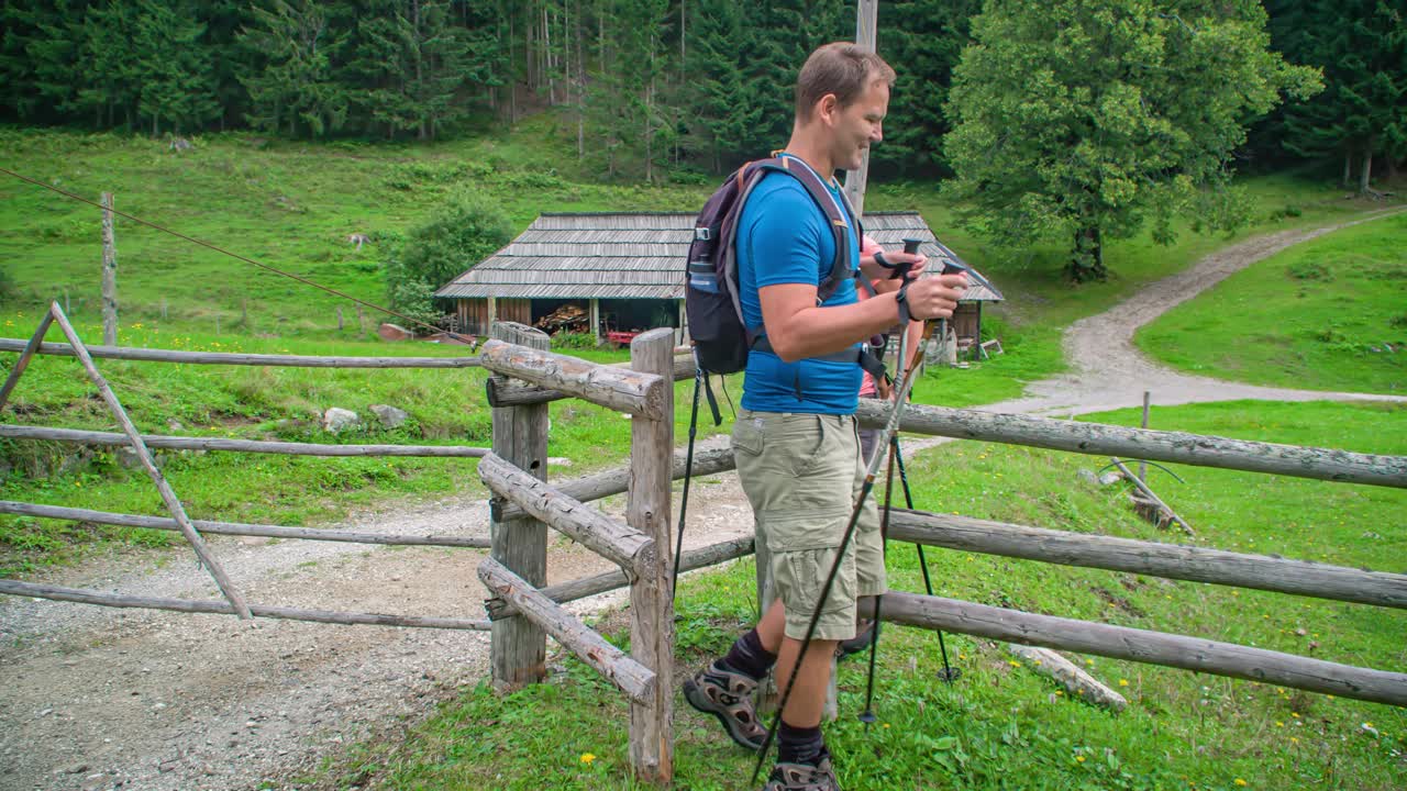 Walking through a gate. Couple points out to a place in nature. Hiking adventure. topla valley, Slovenia