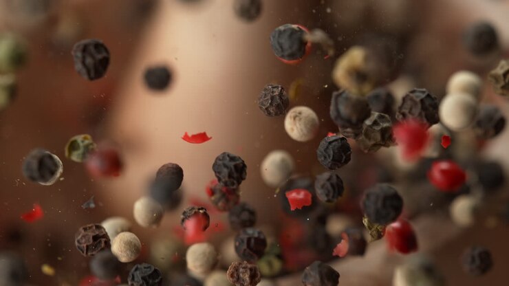 Pestle Crushing A Blend Of Multicolored Pepper In A Wooden Mortar In Slow Motion and Macro