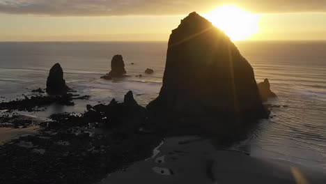 Haystack-Rock-Oregon,-sea-stack-in-Cannon-Beach,-aerial-arc-shot-time-lapse