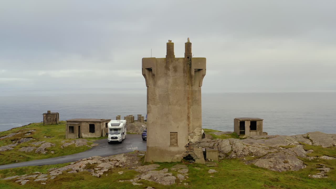 Aerial orbit of Malin Signal Tower with a foggy ocean backdrop. Donegal