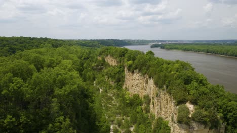 drone reveals horseshoe bluff acting as a natural barrier between canyon floor and the mississippi river