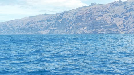 Approaching-a-Breaching-Bottlenose-Dolphin-off-the-Coast-of-Tenerife,-Spain