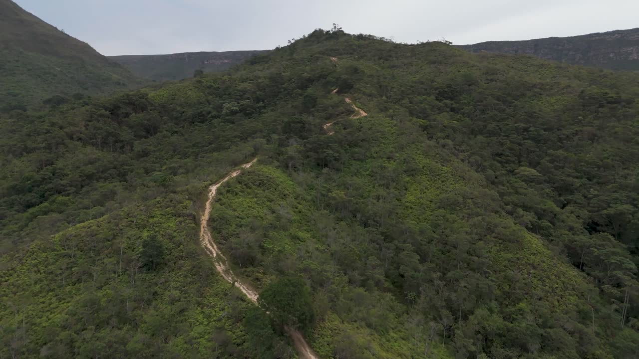 A walking track in Chapada Diamantina National Park going uphill revealing the valley and mountains