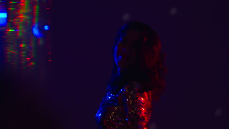 close up of woman in nightclub bar or disco dancing and having fun looking in camera 1