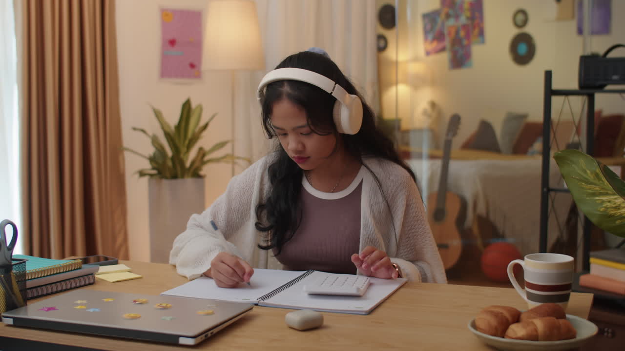 Female Pupil Doing Calculations during Homeschooling