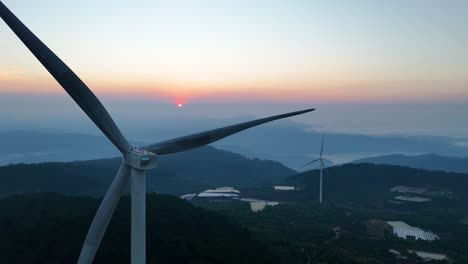 wind turbine blades spin in the bright morning sunlight on the mountain | vietnam