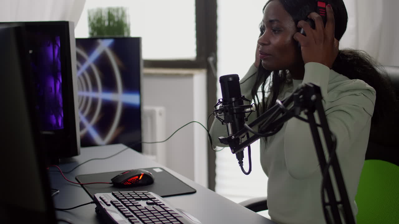 Pro black streamer sitting on gaming chair putting on headset