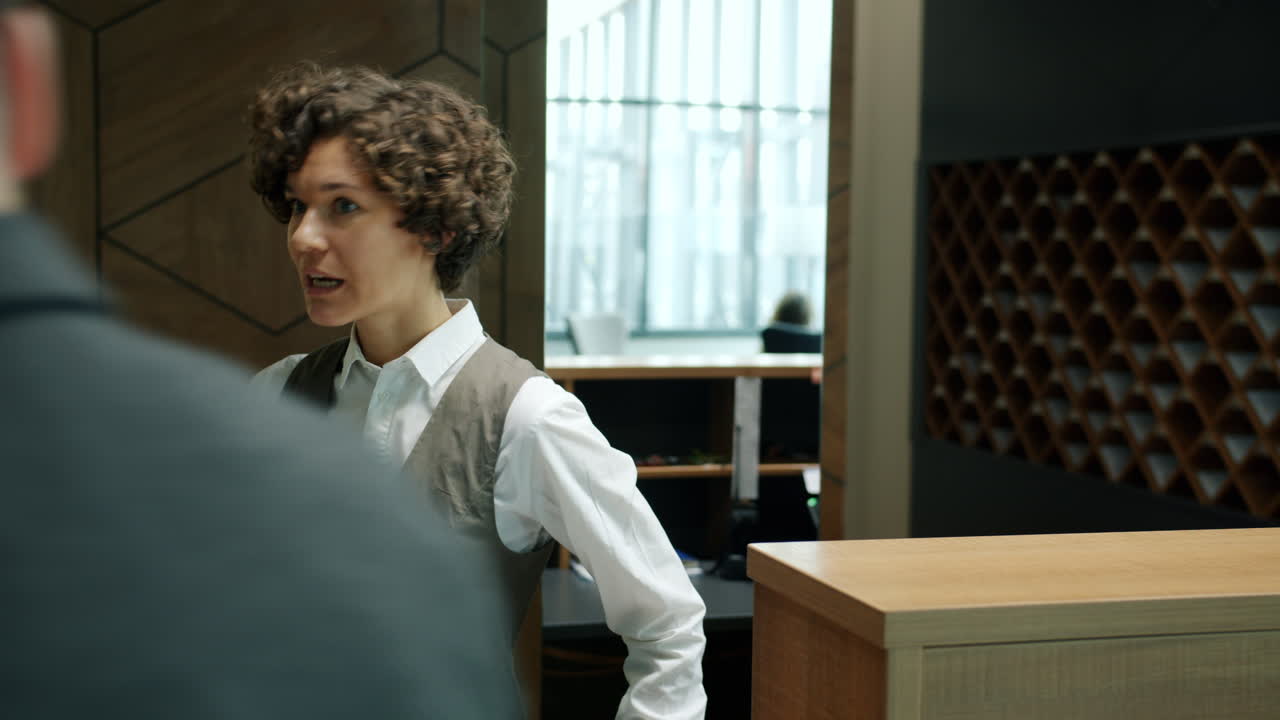 Receptionist greets a visitor