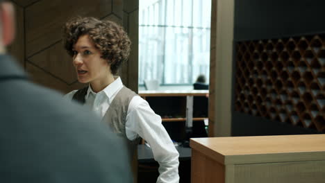 receptionist greets a visitor