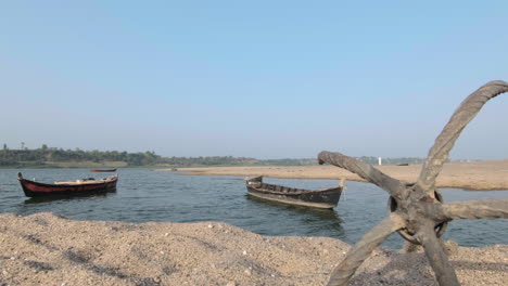 Static-shot-of-wooden-canoes-moored-in-river