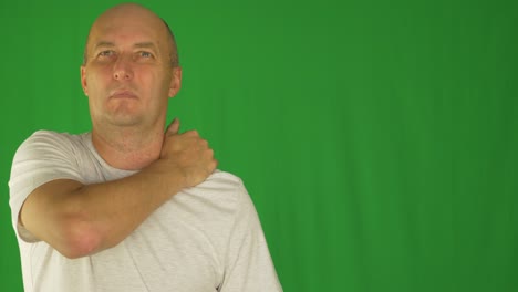 man rubbing neck and shoulders with right hand. extreme close up front view. locked shot.