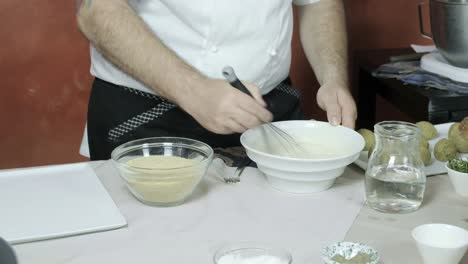 chef preparing batter mixing wheat flour with water salt in professional kitchen of restaurant