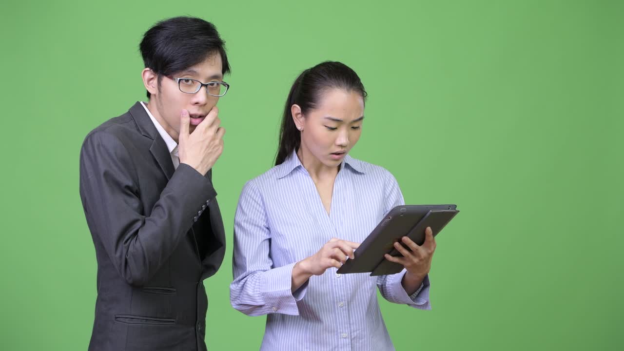 Young Asian business couple having meeting together