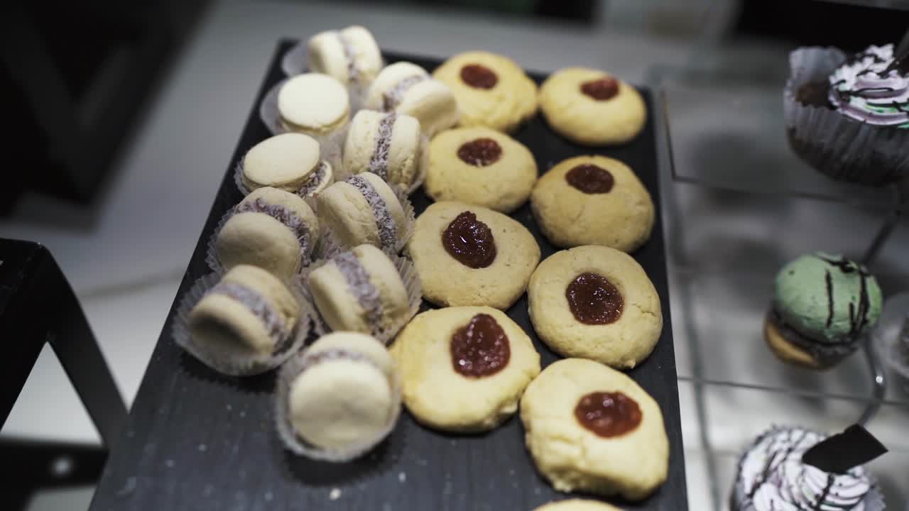 Tray of raspberry jam cookies and assorted cakes, cornstarch alfajor