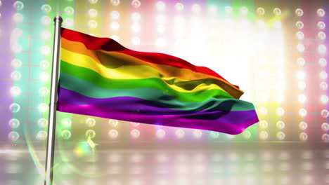 rainbow flag blowing against flashing lights