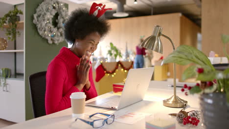 african american casual businesswoman making video call in office at christmas, slow motion