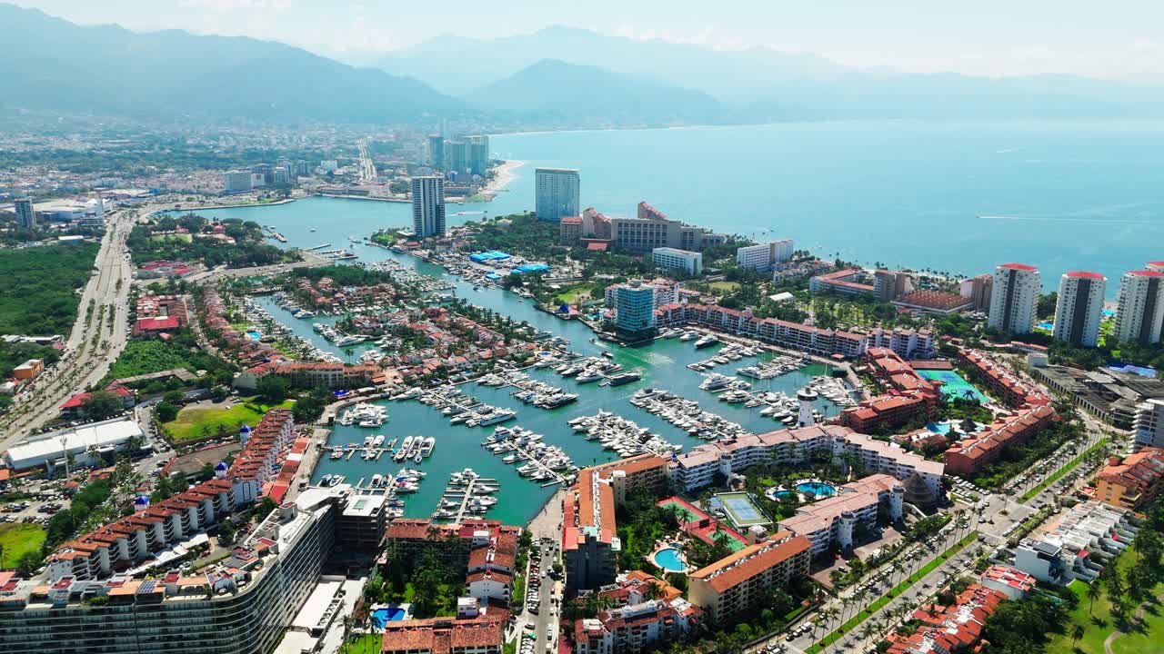 Aerial view of puerto vallarta with luxury yachts, resorts and mountains on the horizon in mexico