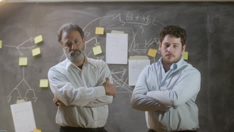 portrait shot of two serious businessmen standing