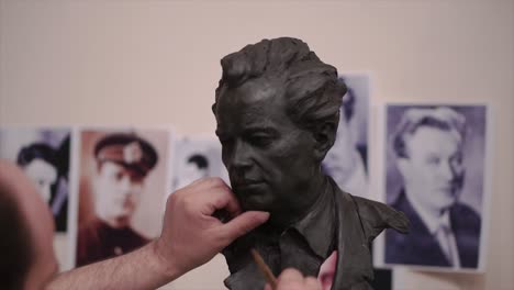 sculpting a clay portrait bust