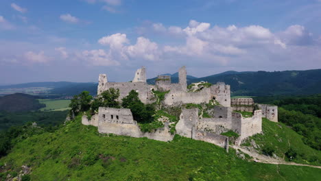 aerial footage of a ruined medieval castle on a hill, slovakia