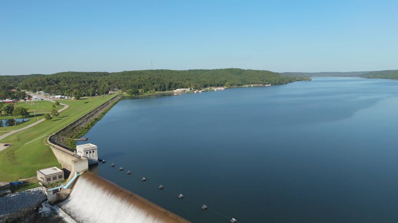 Spavinaw Spillway with water pouring over curved concrete structure in Oklahoma, aerial reveal entire system