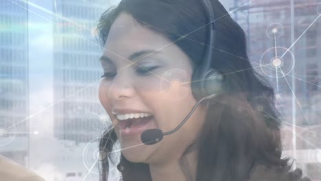 Animation-of-networks-of-connections-over-businesswoman-using-phone-headsets