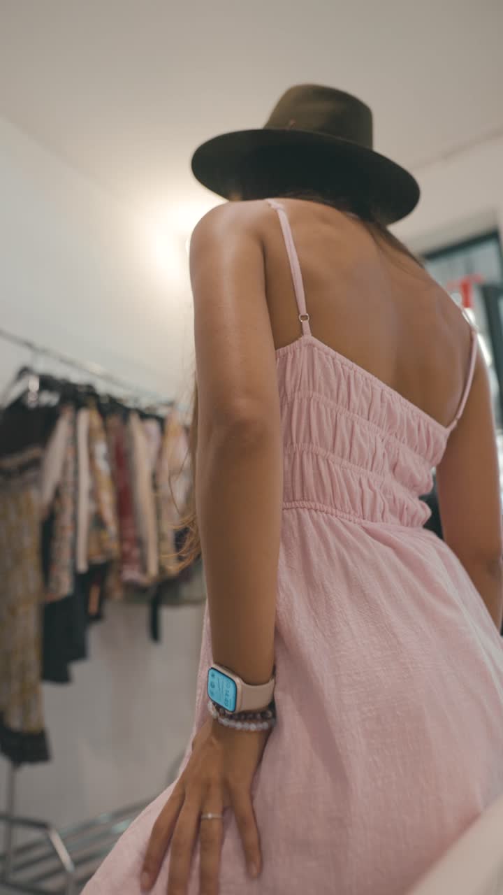 Woman wearing a pink dress and hat