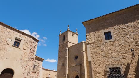 looking up at church tower of cathedral of santa maria in cáceres against clear blue sky