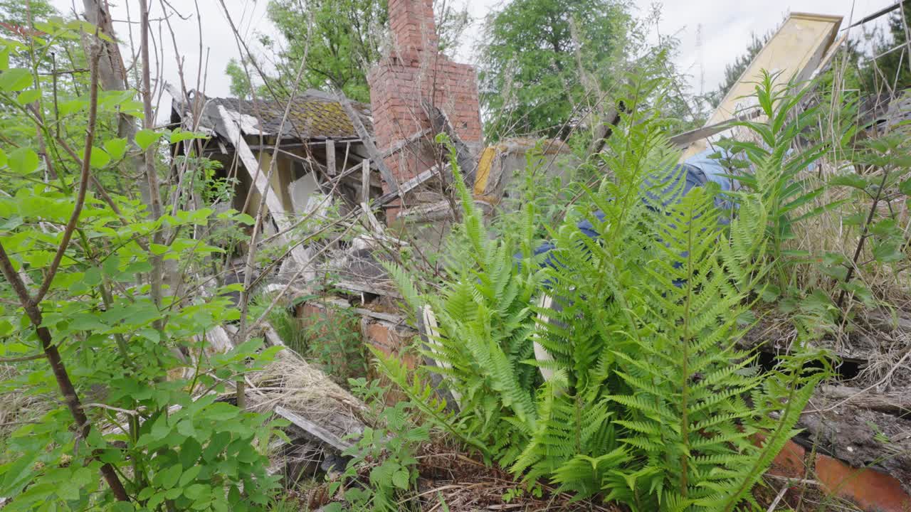 의심되는 시체는 파괴된 건물의 잔디와 파편 사이에 놓여 있습니다.