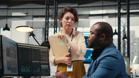 vertical video multiethnic work team consulting each other in completing monthly reports