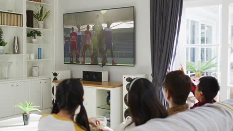 composite of happy family sitting at home together watching hockey match on tv