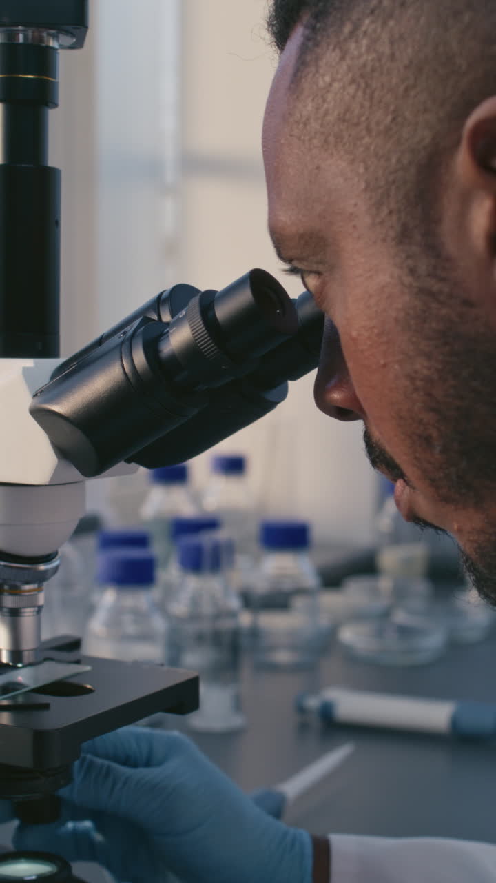 Scientist using a microscope in a laboratory