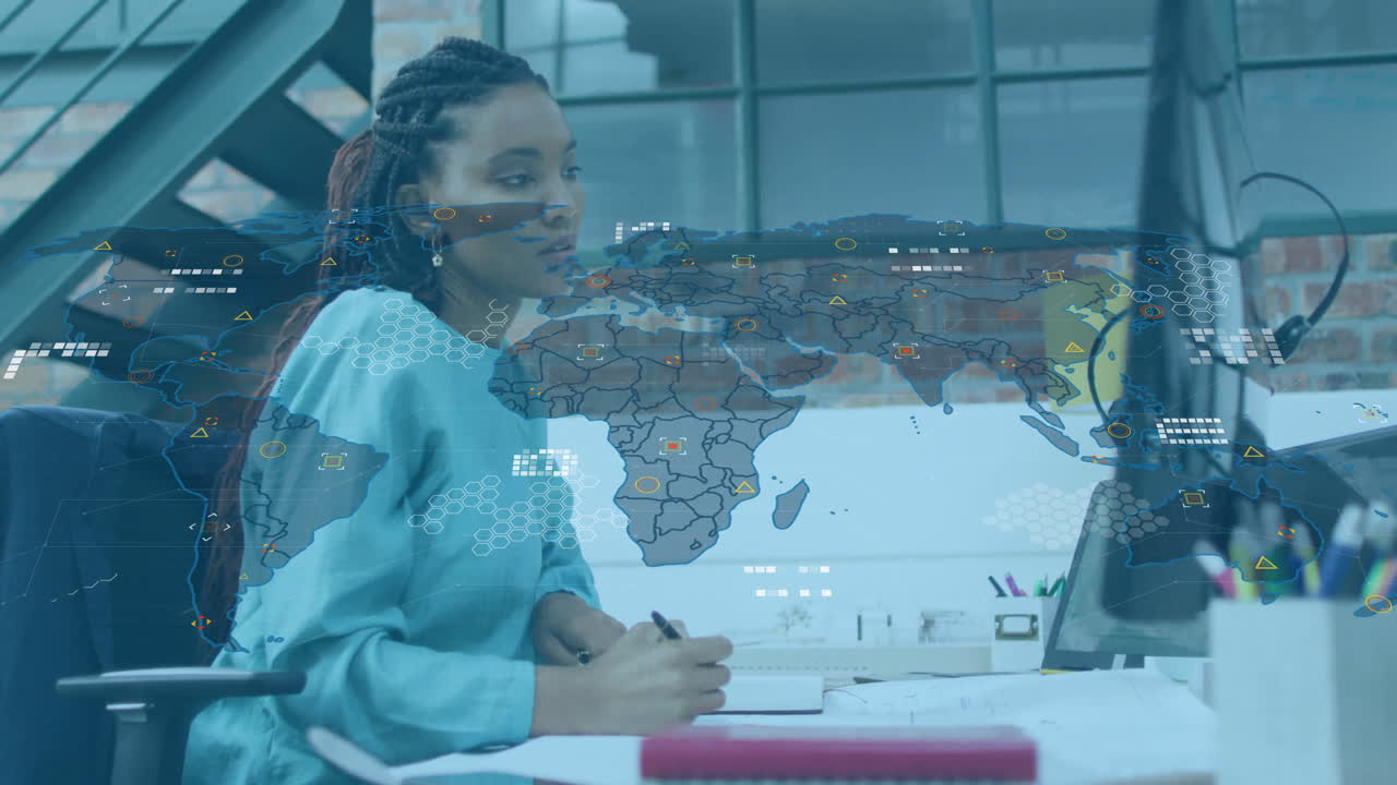 woman writing notebook in technology office, interacting with holographic world map data overlays