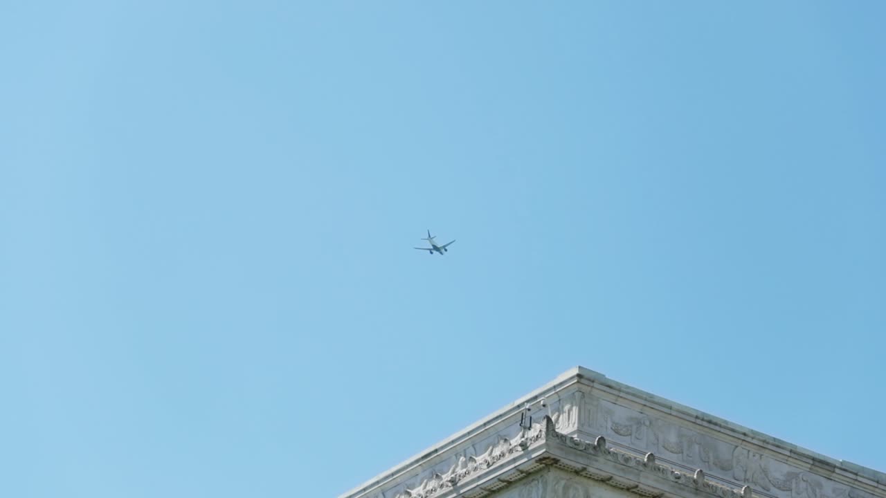 Airplane flying over the beautiful Savior of the Union, the Lincoln Memorial building in Washington, DC, USA.