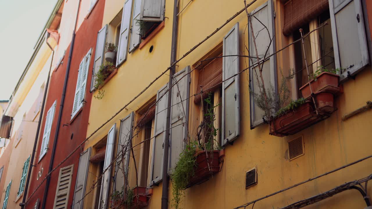 Colorful Italian Building Facades with Shutters and Plants