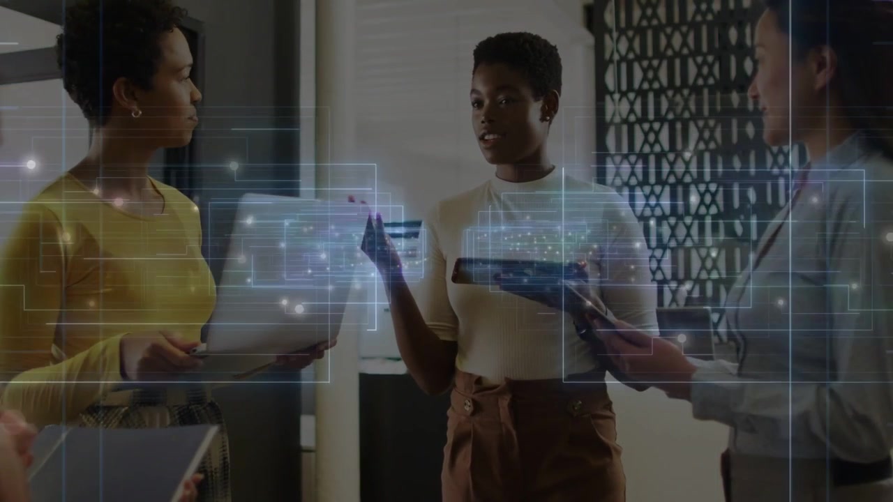 Lead woman initiating tech briefing, guiding team in office, holographic UI annotating tablet data