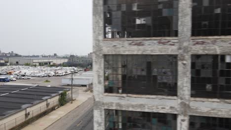 abandoned fisher body automotive plant 21 in detroit, michigan drone shot close up.