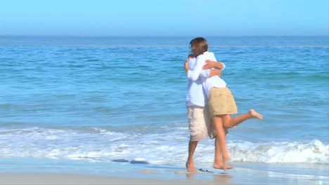 couple meeting and hugging on a beach