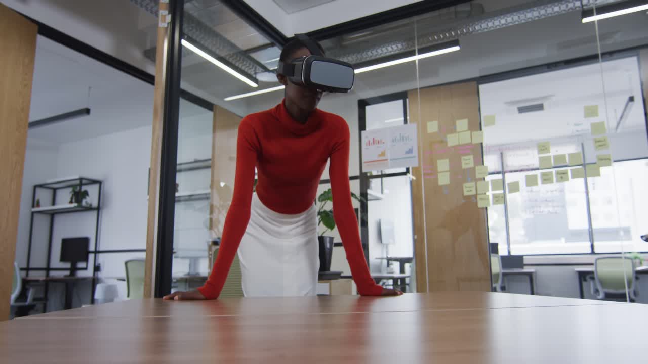 African american woman wearing vr headset at modern office
