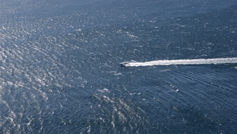 yacht moving fast from right to left at port stephens in east australia, wide long shot