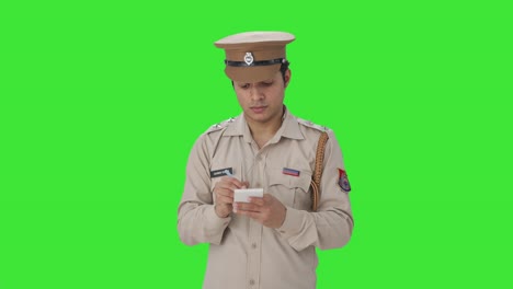 Indian-police-officer-writing-notes-about-the-case-Green-screen