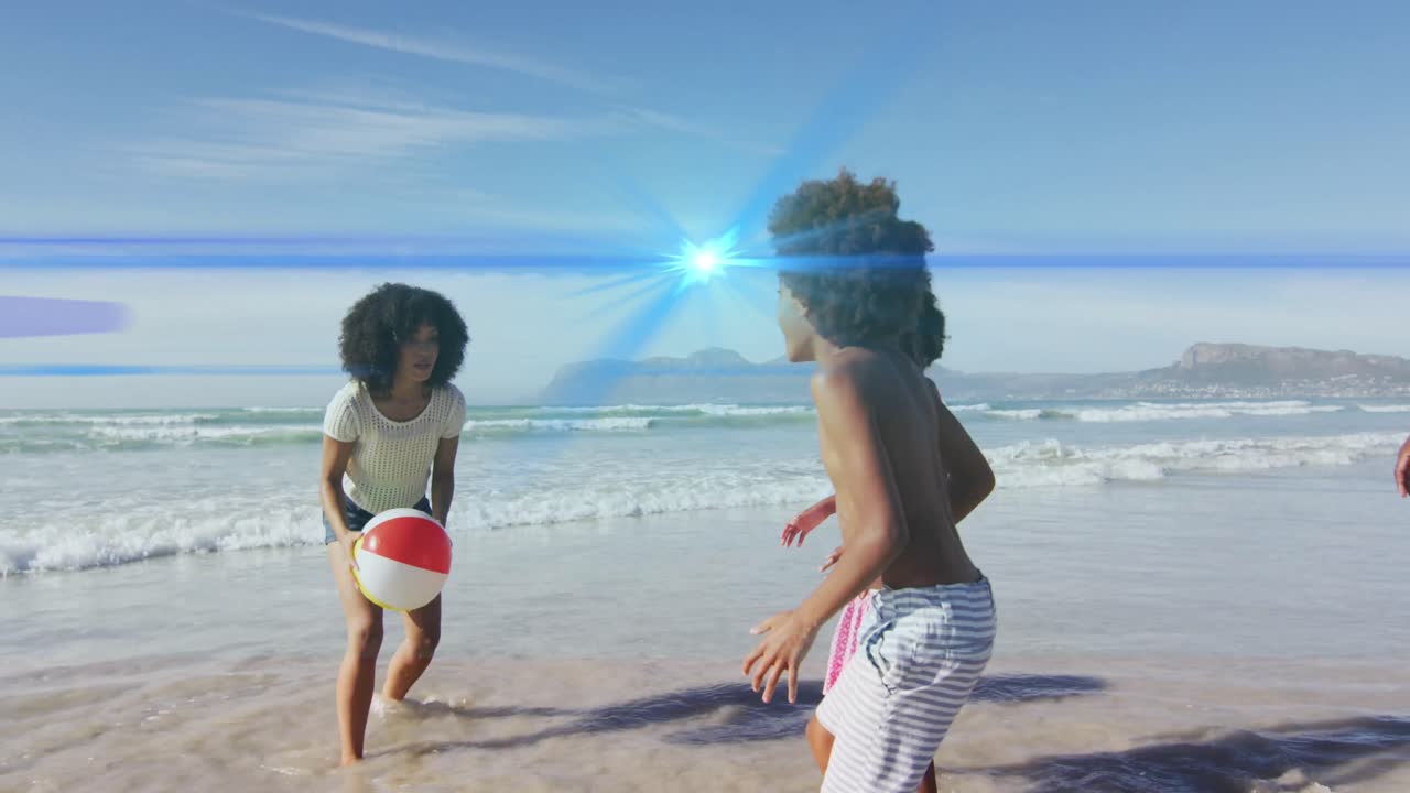 animación de puntos de luz sobre una familia afroamericana en la playa