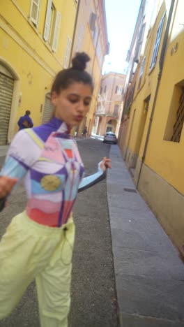 stylish woman in a colorful outfit in a narrow city street