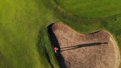 aerial view of male golf player playing golf at the golf course on a bright sunny day