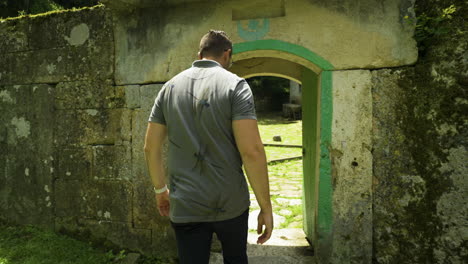 A tourist goes through a narrow entryway to visit the mausoleum of the Alevian saint Demir Baba Teke located in the municipality of Isperih, Razgrad province in Bulgaria.