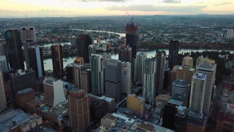 tilting up aerial view of a city with tall buildings in the morning