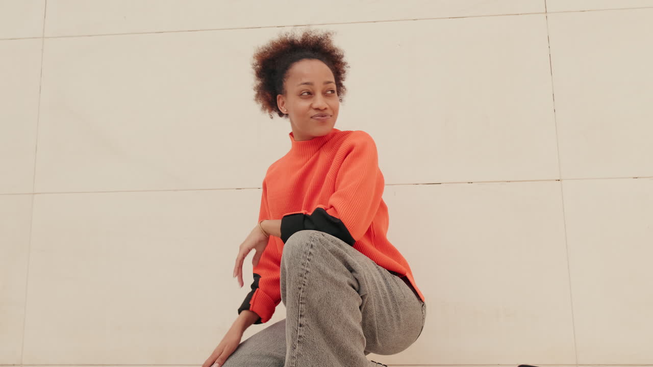 Young Woman Dances While Looking at Her Phone