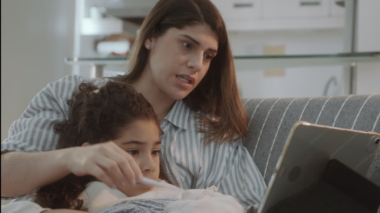 Mother Sitting with Sick Daughter and Web Calling with Doctor