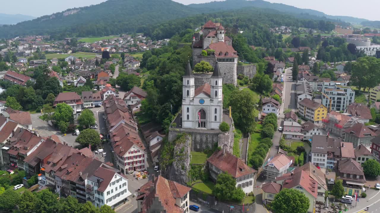 Zoomed-out cityscape with historic structures dominating the central ridge