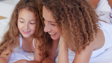 Happy-mother-and-daughter-using-laptop